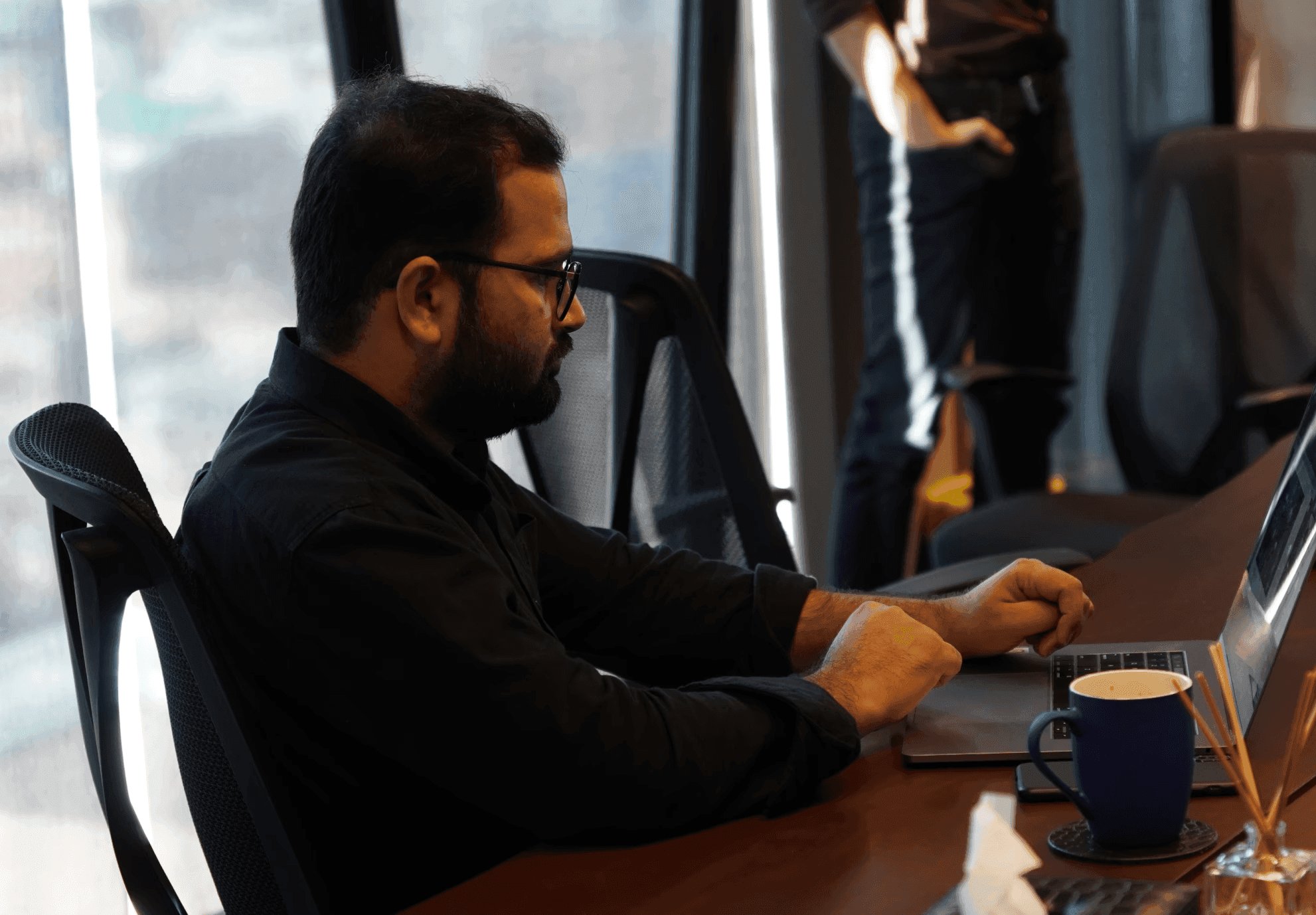 Farrukh working at a desk